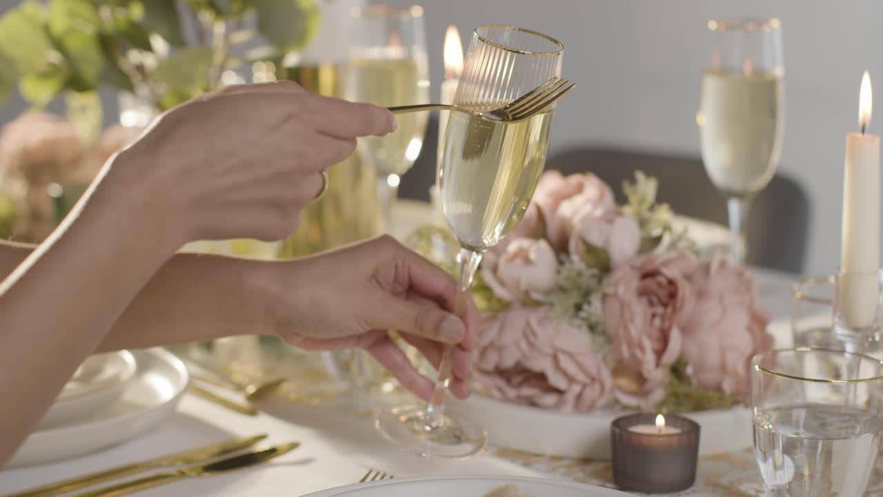 Free stock video Close up of person tapping champagne glass for quiet